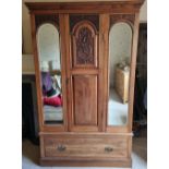 An Edwardian mirror front wardrobe having machine carved decoration, 123 x 46 x 197cm.