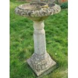 A pre-cast stone pedestal birdbath having hexagonal column, a/f, 106cm hgih.