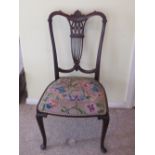 A single mahogany Edwardian side chair having needlepoint seat, and decorative pierced splats.