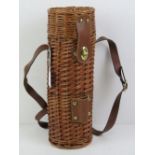 A wicker wine bottle carrier / picnic ha