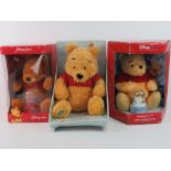 Three Disney Winnie the Pooh plush toys,