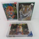 Three unopened puzzles of tigers.