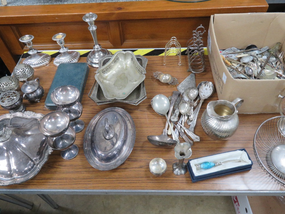 A large quantity of silver plated items including pair of candlesticks, tureens, toast rack,