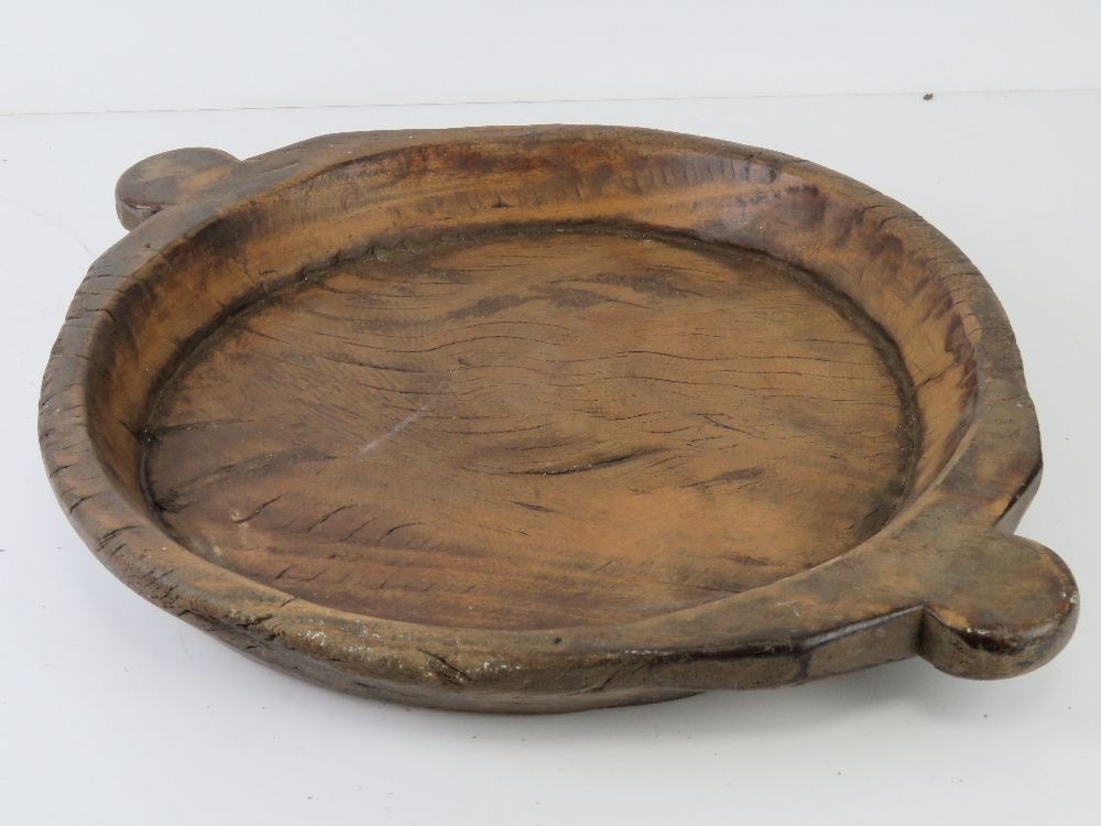 A hand carved wooden tray having lug handles, 53.5cm widest.