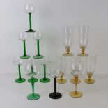 A quantity of assorted green, black and amber coloured stem hock, wine and hi-ball glasses.