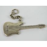 An unusual HM silver key chain in the form of an electric guitar, guitar measuring 5.