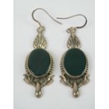 A pair of large silver earrings having central green oval panel and acanthus style decoration,