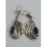 A pair of handmade lapis lazuli earrings having designer name to back, designer indistinct,