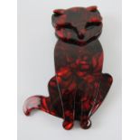 An overlaid plastic brooch in the style of Lea Stein in the form of a red cat, 7.5cm high.