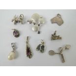 A quantity of silver and white metal charms and pendants including; cat with ball,