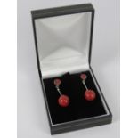 A pair of modern faux coral and silver earrings, stamped 925, with butterfly backs,