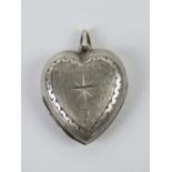 A silver locket in the form of a heart, stamped silver and measuring 3cm inc bale.