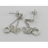 A pair of silver butterfly and floral drop earrings, stamped 925 with 925 silver butterfly backs,