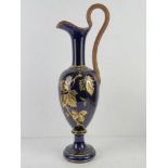 A large blue ground and gilded ewer, a/f, marked to base P.E Peret Dellores. Naive repair.