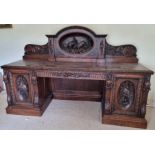 A fine and impressive Victorian carved oak chiffonier sideboard.