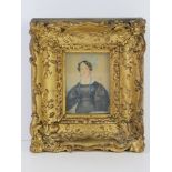 A late 18th early 19th century miniature watercolour portrait on paper of a woman in lace and