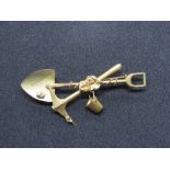 A 15ct gold South Africa mining themed brooch comprising pick, spade and bucket, stamped 15, 7.6g.