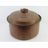A large copper lidded cooking pot approx 38cm dia.