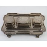 An HM silver partners desk type standish having pen tray to each side with central stamp tray and