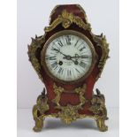 A late 19thC mantle clock having white enamelled dial marked for Howell & Games (?? indistinct),
