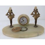 An art deco onyx desk clock having central garniture a/f flanked by two female figurines (a/f) with