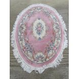 An oval woolen rug 148 x 210cm.