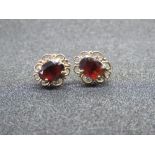 A pair of garnet earrings, filigree frame, with 9ct gold butterfly backs, indistinct marks to stud.