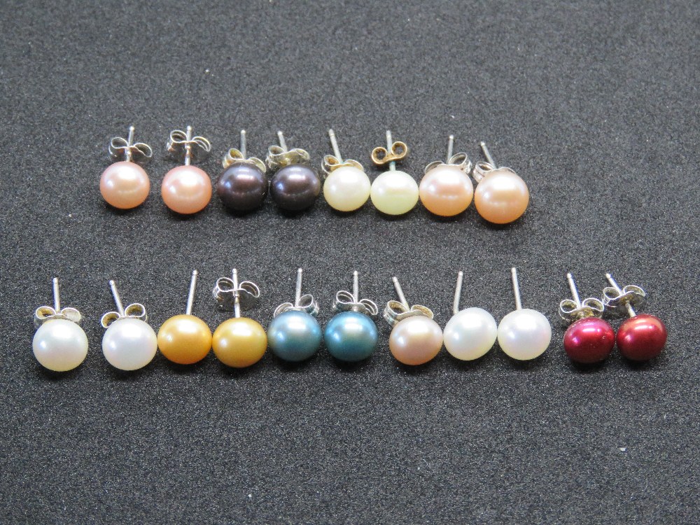 Nine pairs of coloured pearl stud earrings, also one odd pearl earring.