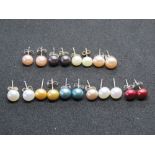 Nine pairs of coloured pearl stud earrings, also one odd pearl earring.