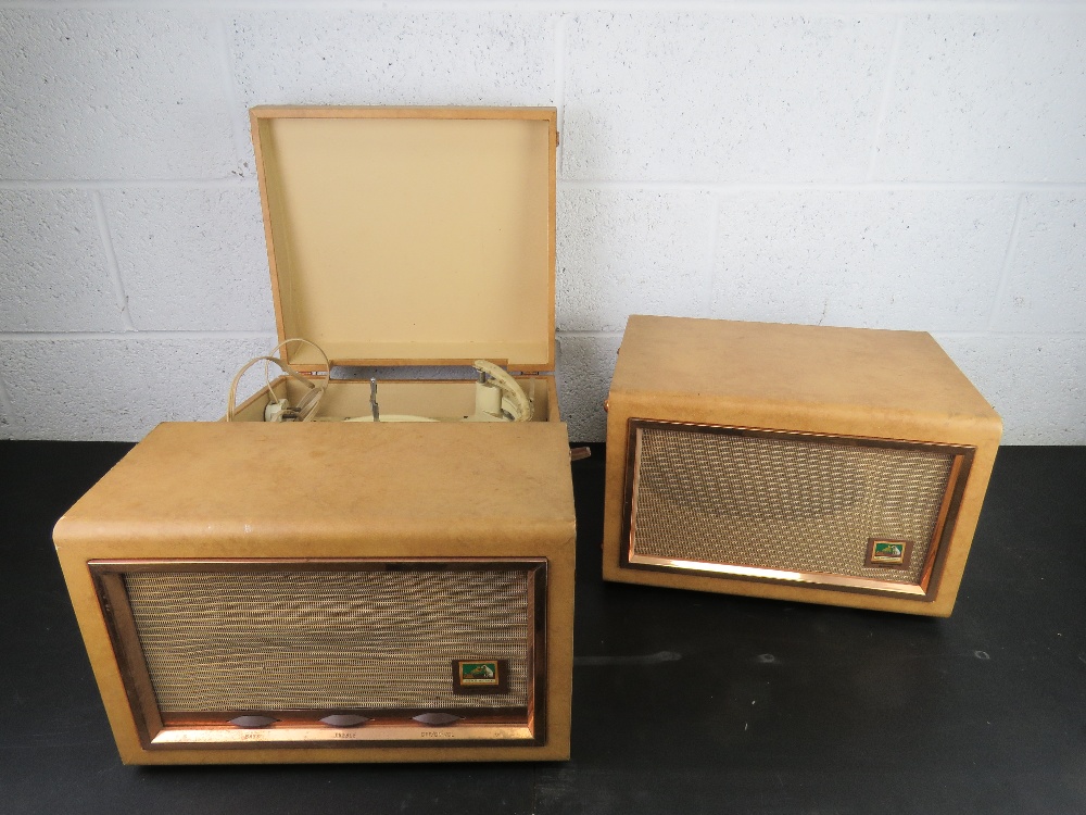 A portable record player with matching speaker by HMV.