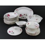 A white ground dinner service decorated with purple roses inc lidded tureen, serving plate,
