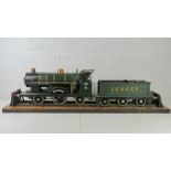 A 3 1/2" gauge scale model live steam engine L.B & S.C.R 2.2.2 locomotive and tender on stand.