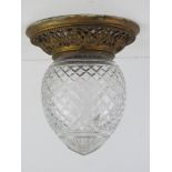 A cut glass and brass ceiling light fitting approx 21cm dia at widest x 23cm high.