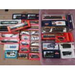 A large quantity of assorted 00 gauge scale model railway locomotive and carriages in boxes.