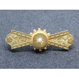 A 9ct gold brooch having central seed pearl and floral pattern upon, hallmarked 375, 3.4g.