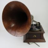 An HMV table top wind up gramophone with handle, wooden detachable horn and gramola stylus.