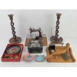 A pair of carved wooden candlesticks together with crumb tray brush, two enamel copper pin trays,