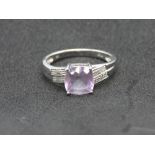 A 9ct white gold and amethyst ring, central cushion cut lilac stone, stamped 9k, size P, 2.7g.