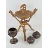 A quantity of hand carved wooden African items inc bowl on triform stand,