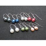 Seven pairs of coloured pearl earrings.