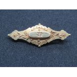 A 15ct gold Victorian brooch having glazed mourning locket to back,