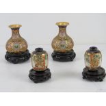 A pair of Canton enamelled cloisonné short vases with Oriental hardwood stands, vases standing 9.