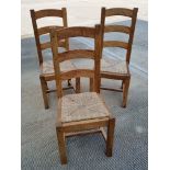 Three contemporary oak framed dining chairs.