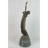 A contemporary bronze of a partially dressed female in the classical style raised over serpentine