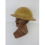 A rare WWII South African Brodie helmet with three sunshade holes.