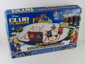 A Disney Club penguin air hockey playset.