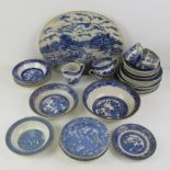 A quantity of blue and white ceramics, mostly Old Willow pattern.