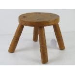 A small pine four-legged stool, 21cm dia.