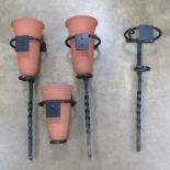 A quantity of black painted metal and terracotta wall planters.