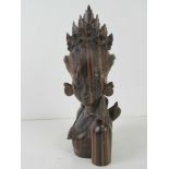 A Balinese carved wooden figurine of a goddess, 21cm high.
